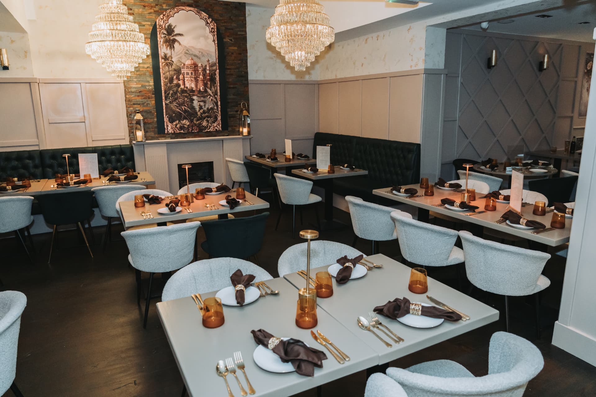 The Anaya dining room set for service beneath crystal chandeliers