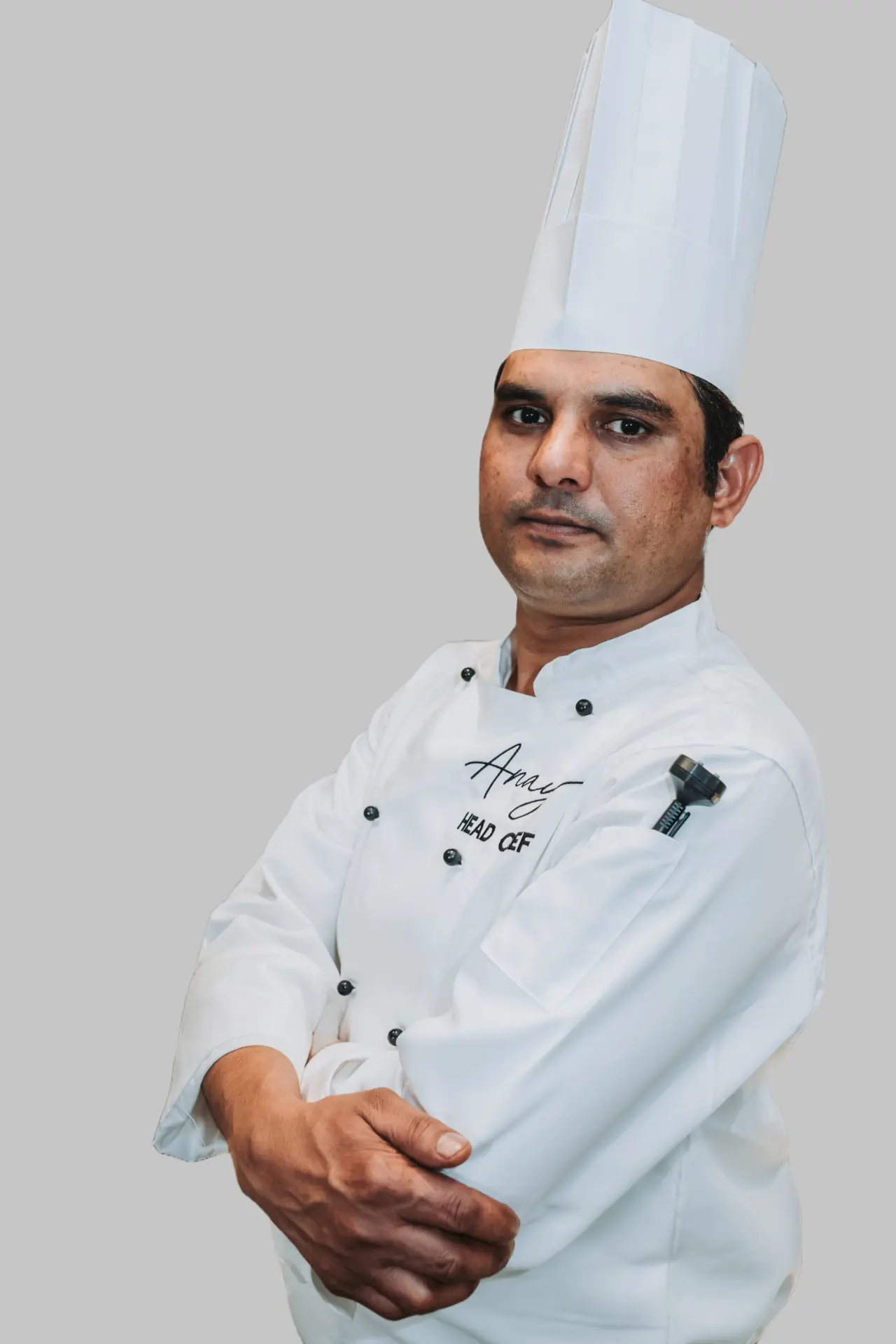 Anaya's head chef in whites, arms crossed