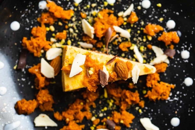 Carrot halwa dessert plated with pistachio and almond