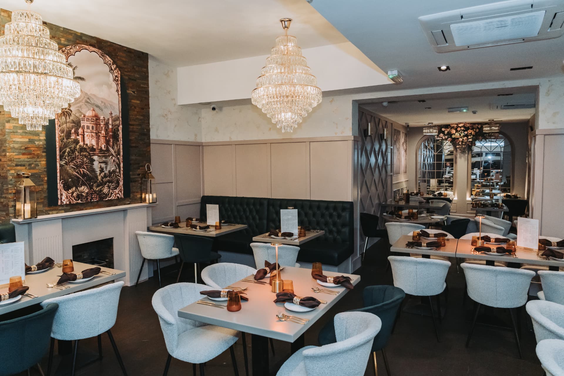 Rows of prepared tables and tufted banquette seating at Anaya