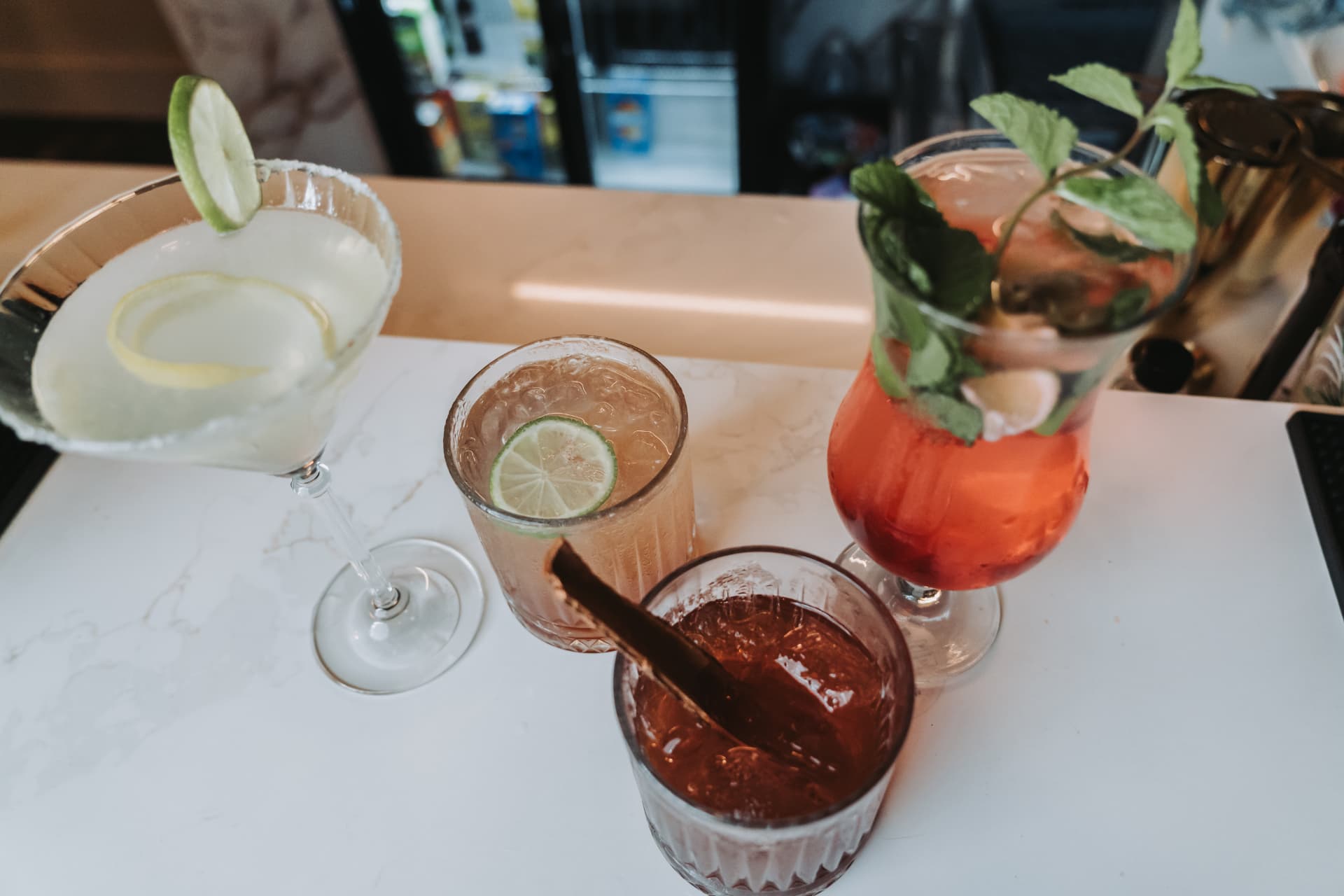 An overhead view of four garnished cocktails at the Anaya bar