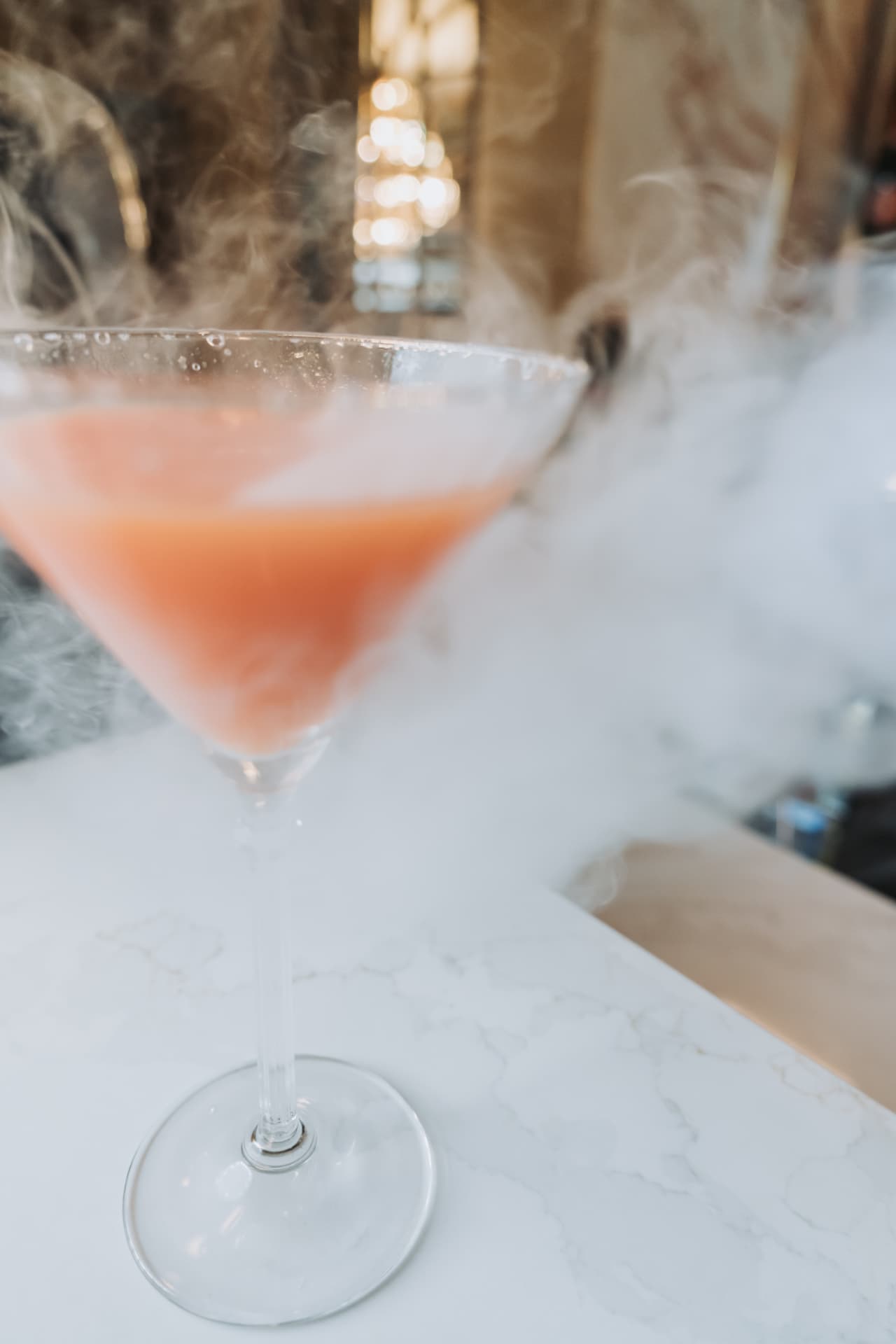 A smoked orange cocktail under a cloud of white smoke at Anaya